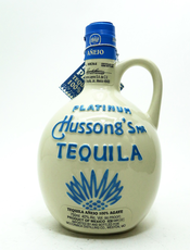 Hussongs Platinum Anejo Tequila 750 ML in a clay jug with blue branding.
