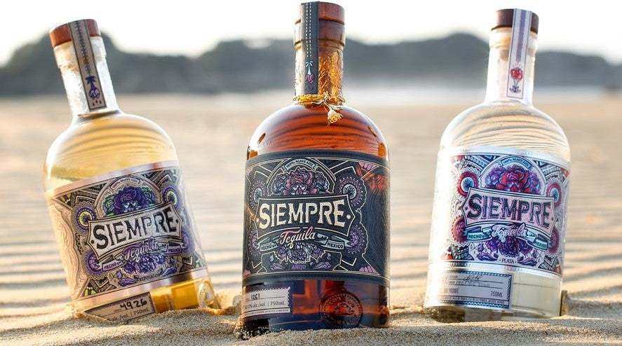 Siempre Tequila Combo 750 ML three bottle set showcasing premium 100% blue weber agave tequila on sand background